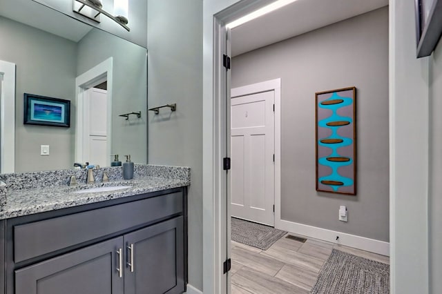 bathroom with hardwood / wood-style floors and vanity