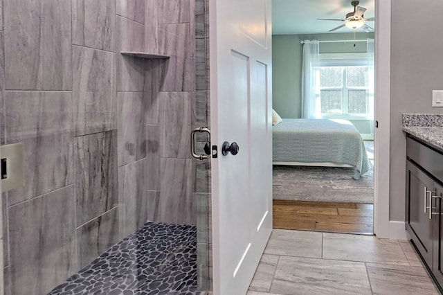 bathroom with hardwood / wood-style flooring, vanity, ceiling fan, and a shower with door