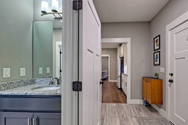 bathroom featuring hardwood / wood-style floors and vanity