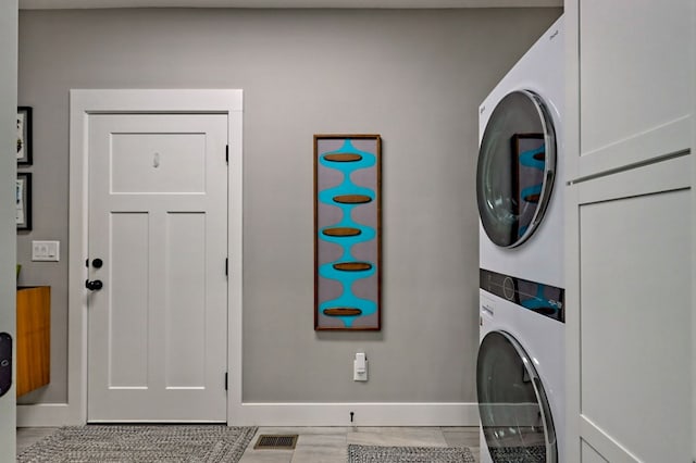 laundry room with stacked washer and dryer