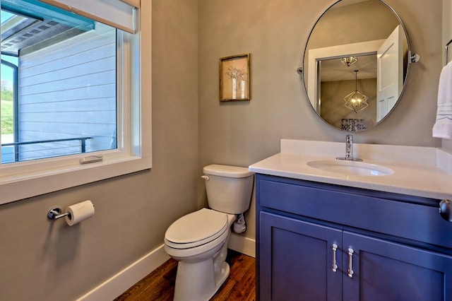 bathroom with hardwood / wood-style floors, vanity, and toilet