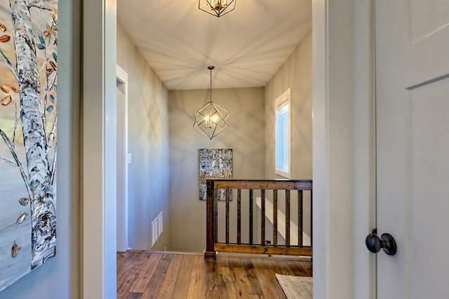 entryway with hardwood / wood-style flooring and an inviting chandelier