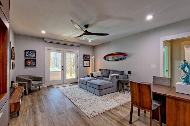 living room featuring ceiling fan, light wood-type flooring, and french doors