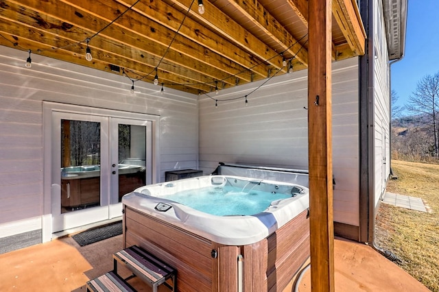 view of patio / terrace with french doors and a hot tub