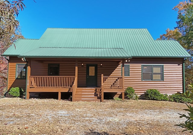 log-style house with covered porch