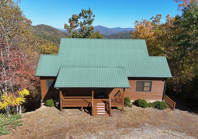 view of front of home with a deck with mountain view