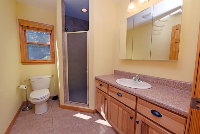 bathroom featuring toilet, vanity, tile patterned floors, and a shower with door