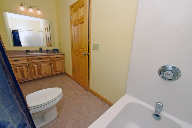 bathroom with tile patterned flooring, vanity, and toilet