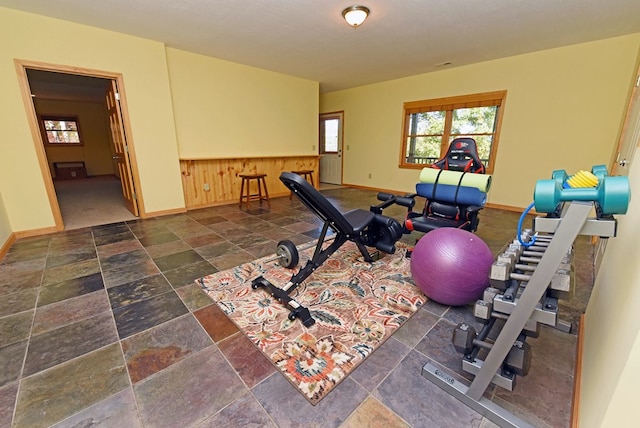 workout area featuring wood walls