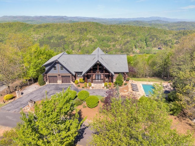 aerial view featuring a wooded view