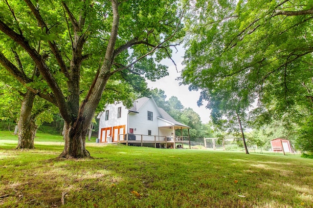 view of home's exterior featuring a deck and a yard