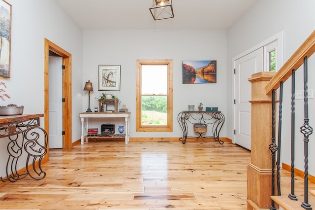 entrance foyer featuring light hardwood / wood-style floors and a healthy amount of sunlight