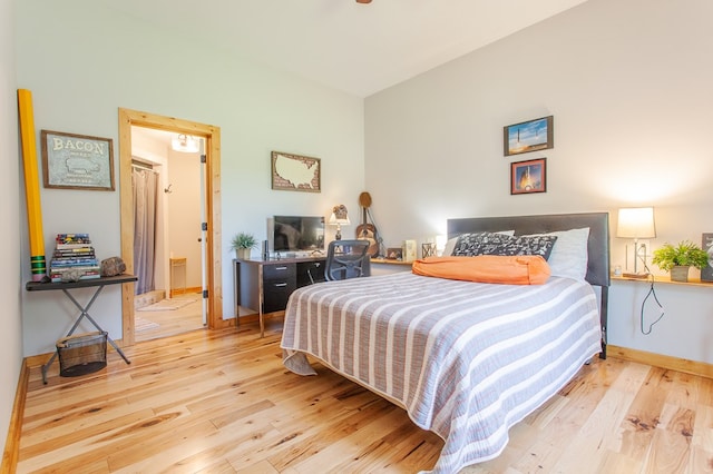 bedroom featuring light hardwood / wood-style flooring and ensuite bath