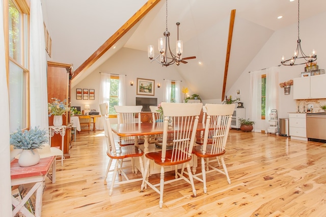 dining space featuring high vaulted ceiling, light wood-type flooring, an inviting chandelier, and beamed ceiling