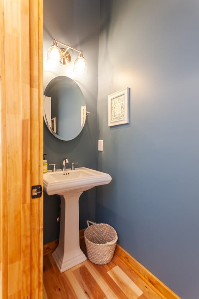 bathroom with hardwood / wood-style flooring and sink