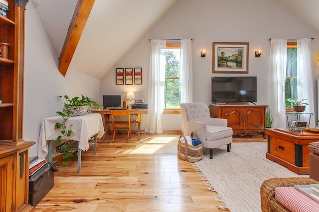 living room with vaulted ceiling with beams and light hardwood / wood-style flooring