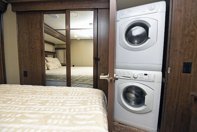 washroom with stacked washer and clothes dryer