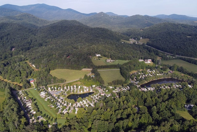 drone / aerial view with a water and mountain view