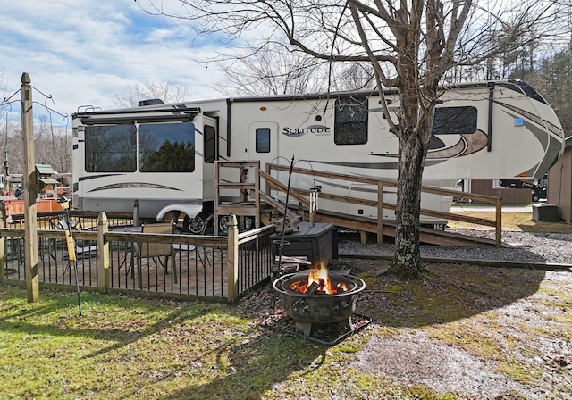 back of house featuring an outdoor fire pit