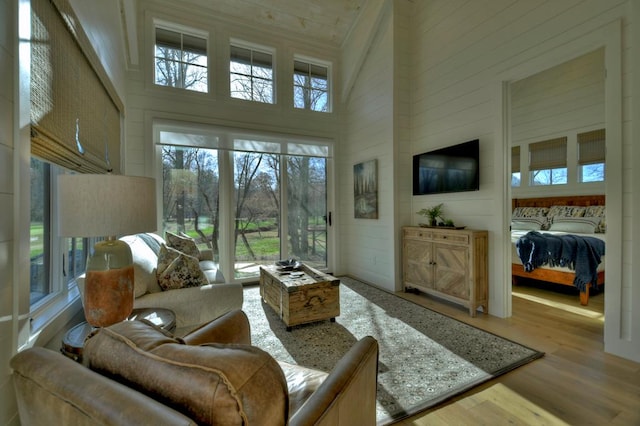 living room with a high ceiling and wood finished floors