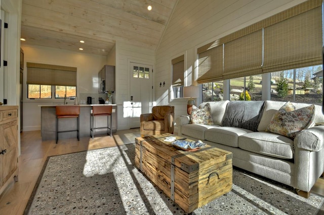 living room featuring recessed lighting, lofted ceiling, and wood finished floors