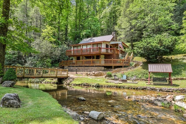 back of house with a deck with water view