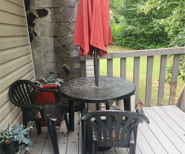 deck featuring a yard and outdoor dining area