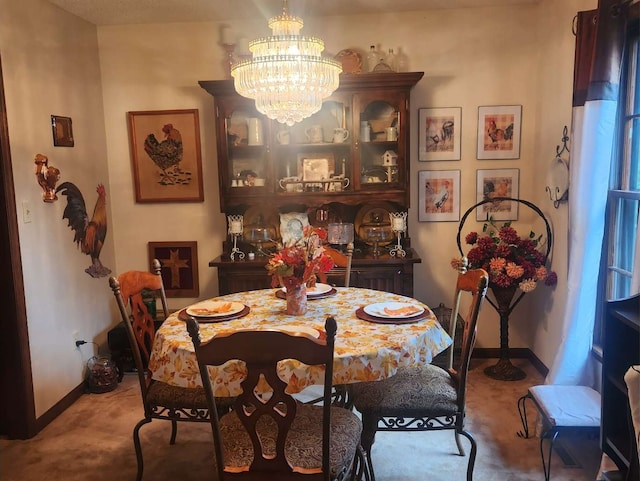 carpeted dining area featuring a chandelier and baseboards