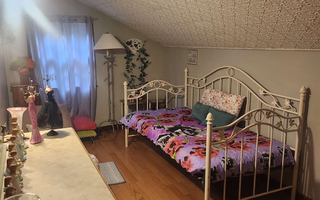 bedroom featuring wood finished floors and an ornate ceiling