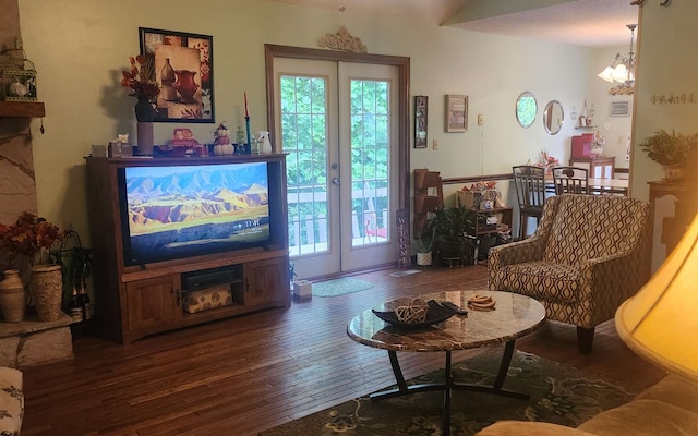 living room featuring hardwood / wood-style floors, a chandelier, and french doors