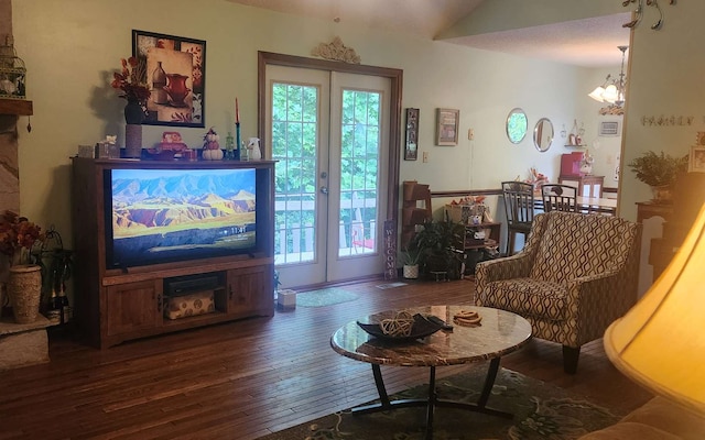 living room with wood-type flooring, plenty of natural light, and a chandelier