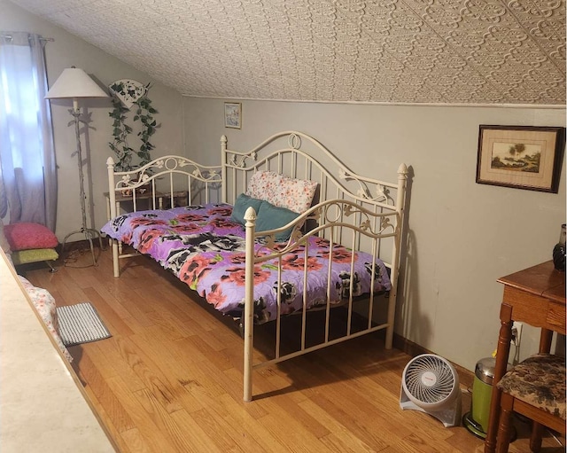 bedroom featuring wood finished floors and an ornate ceiling
