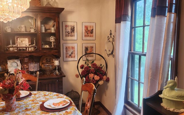dining space with healthy amount of natural light and a chandelier