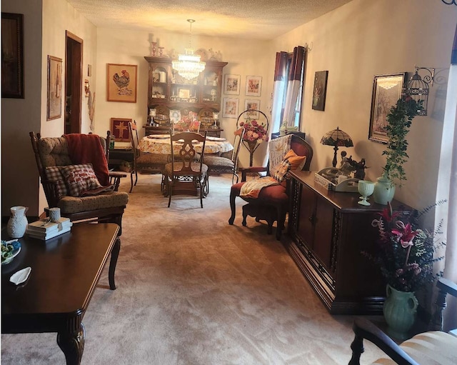 carpeted living room featuring a textured ceiling and a chandelier