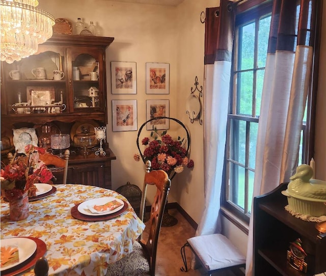 dining space with a chandelier and baseboards