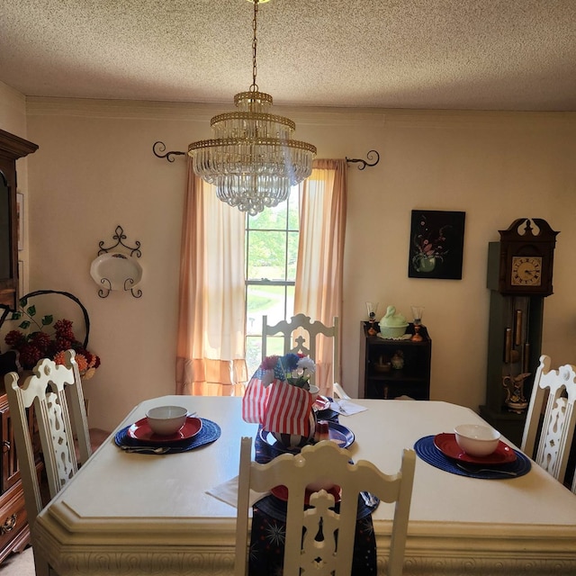 dining space with a chandelier and a textured ceiling