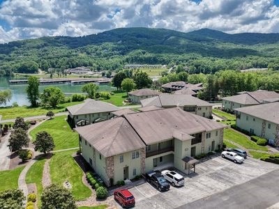 birds eye view of property featuring a water and mountain view