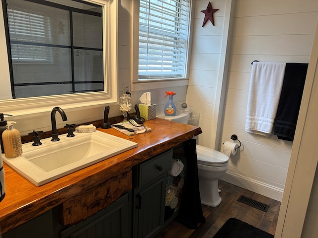 bathroom featuring hardwood / wood-style flooring, vanity, and toilet