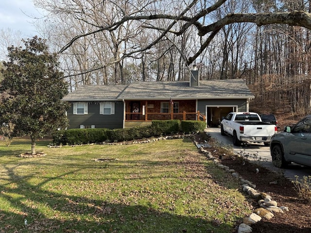 single story home with a garage, a front yard, and covered porch