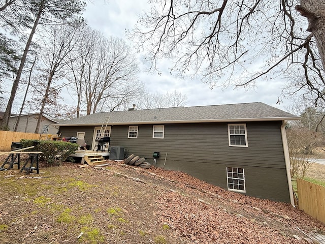 back of house featuring cooling unit and a wooden deck