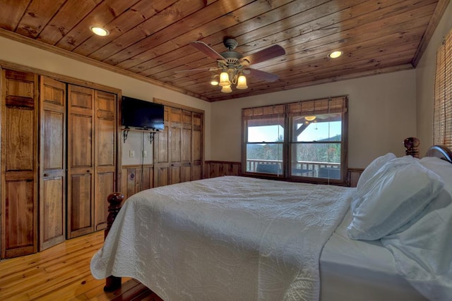 bedroom with light hardwood / wood-style floors, wooden ceiling, ceiling fan, and crown molding