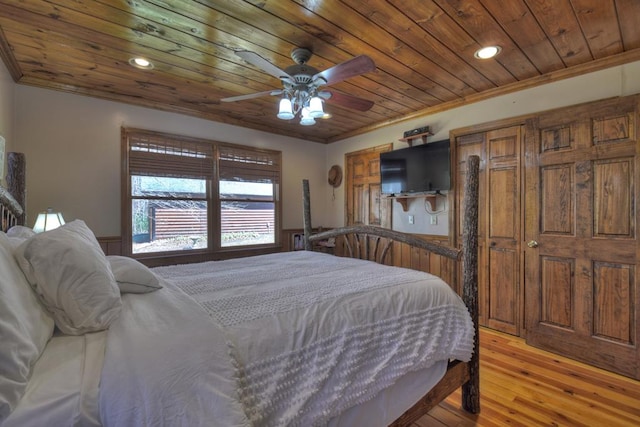 bedroom featuring crown molding, wooden ceiling, ceiling fan, and light wood-type flooring