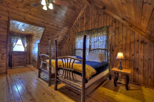 bedroom featuring ceiling fan, wood ceiling, light hardwood / wood-style flooring, wood walls, and lofted ceiling