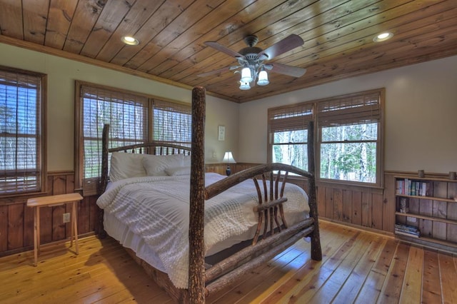 bedroom featuring wood ceiling, crown molding, light hardwood / wood-style floors, and ceiling fan