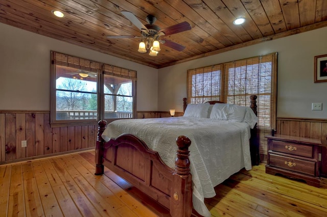 bedroom with wooden ceiling, ceiling fan, and light hardwood / wood-style flooring