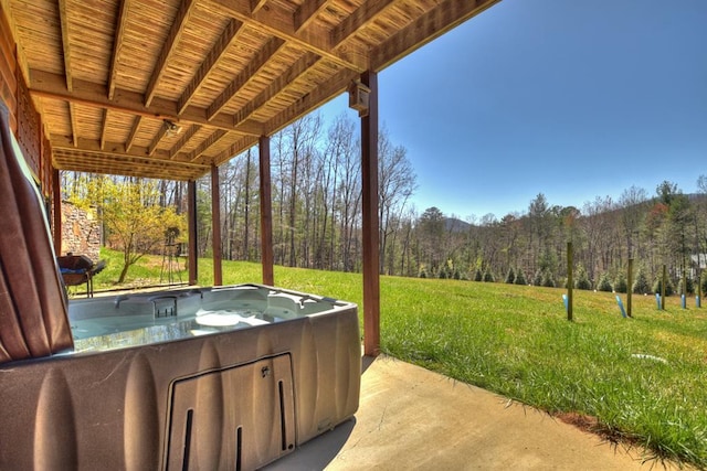 view of patio / terrace with a hot tub