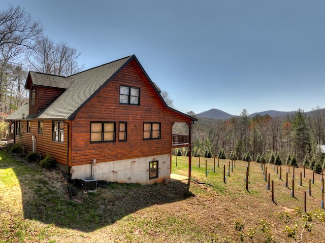 view of property exterior featuring central AC and a yard