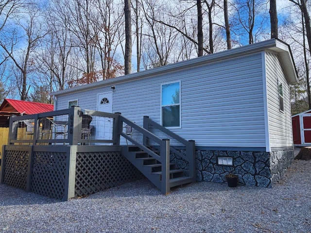 back of house featuring a wooden deck