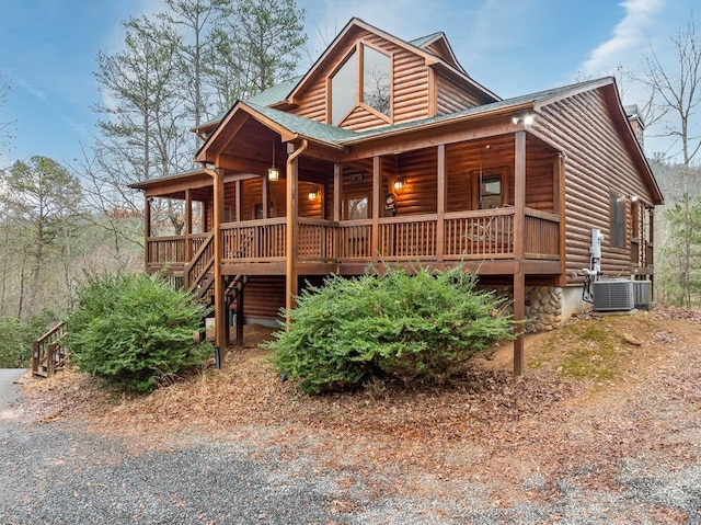 log-style house with a porch and cooling unit