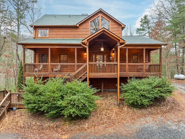 log home featuring a porch